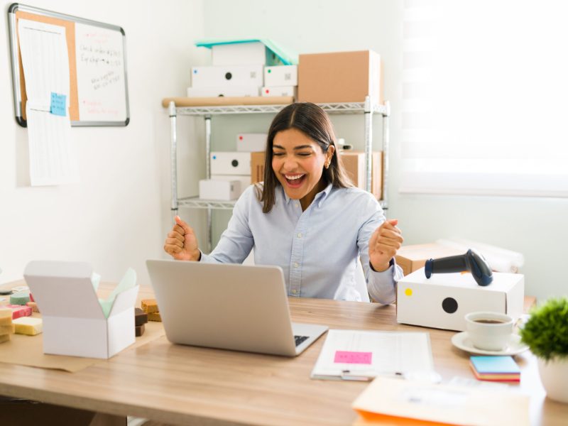 I can't believe it. Excited female entrepreneur looking surprised and shouting with happiness because all of the online customers orders